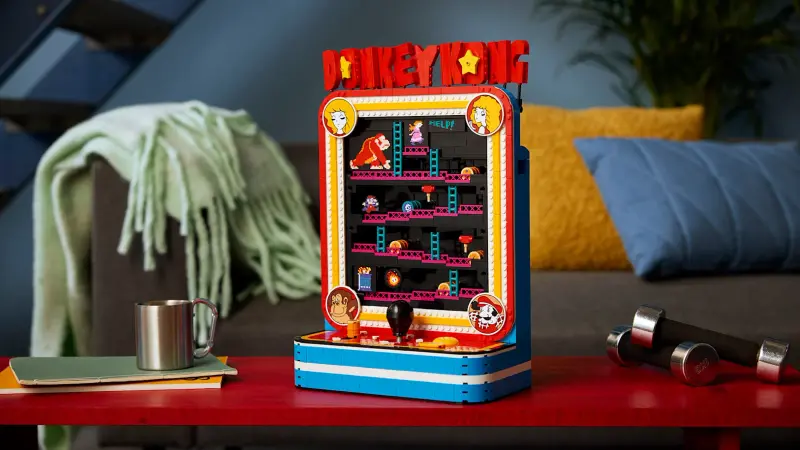 The assembled LEGO Donkey Kong Arcade set displayed on a table in a living room, recreating the cabinet's screen and joystick