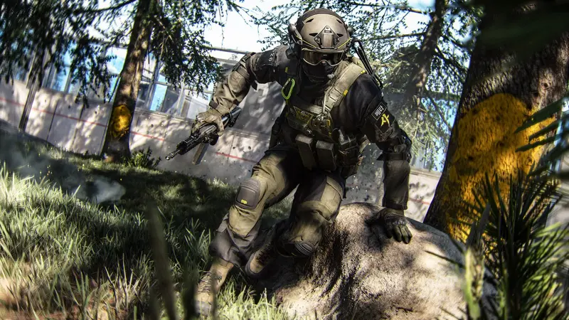 A Modern Warfare 4 operator in tan and green fatigues crouched on a rock in sunlit woodland, rifle lowered